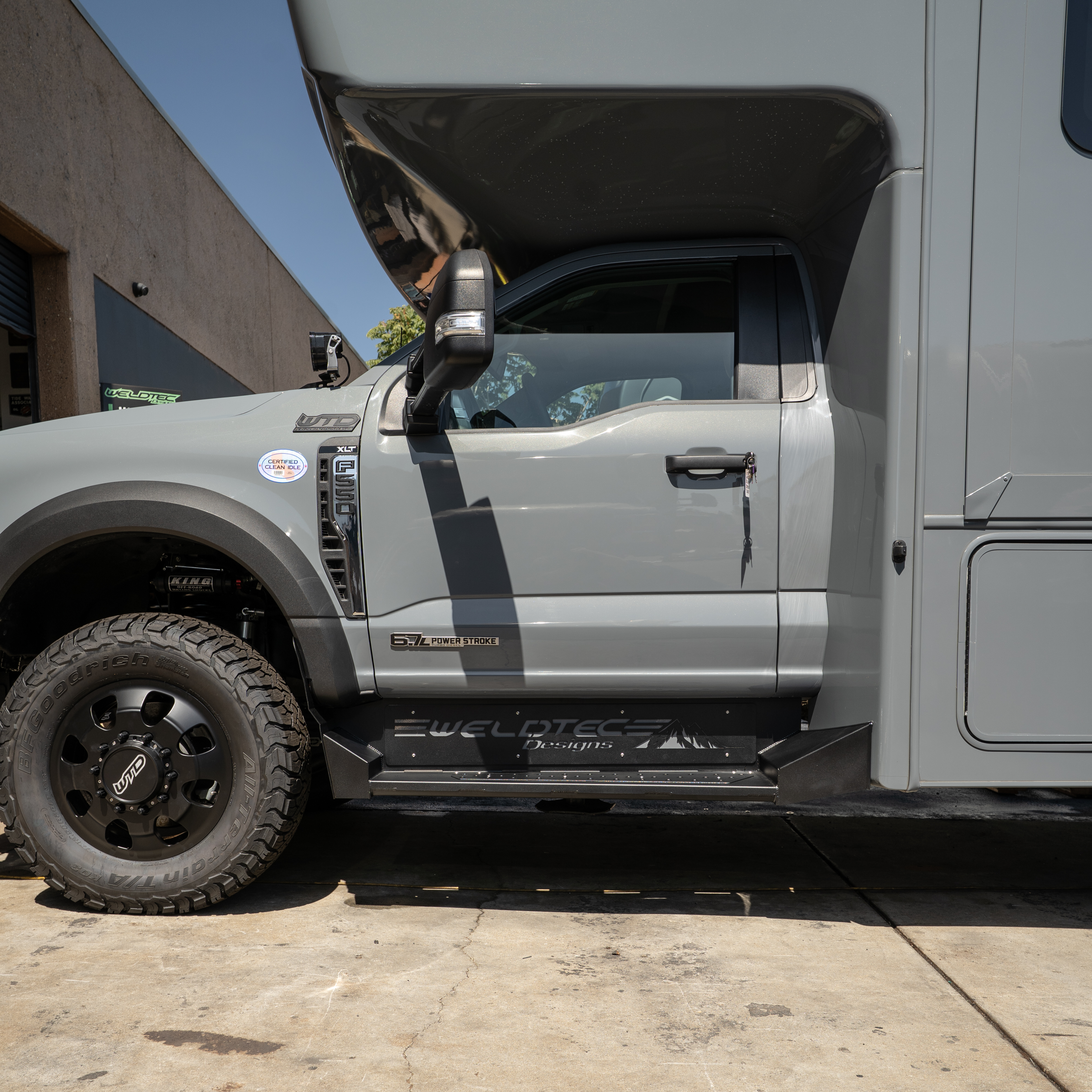 WeldTec Designs side steps for Ford F-550 and F-600 Super C RVs with wide step surface and integrated body-line fitment