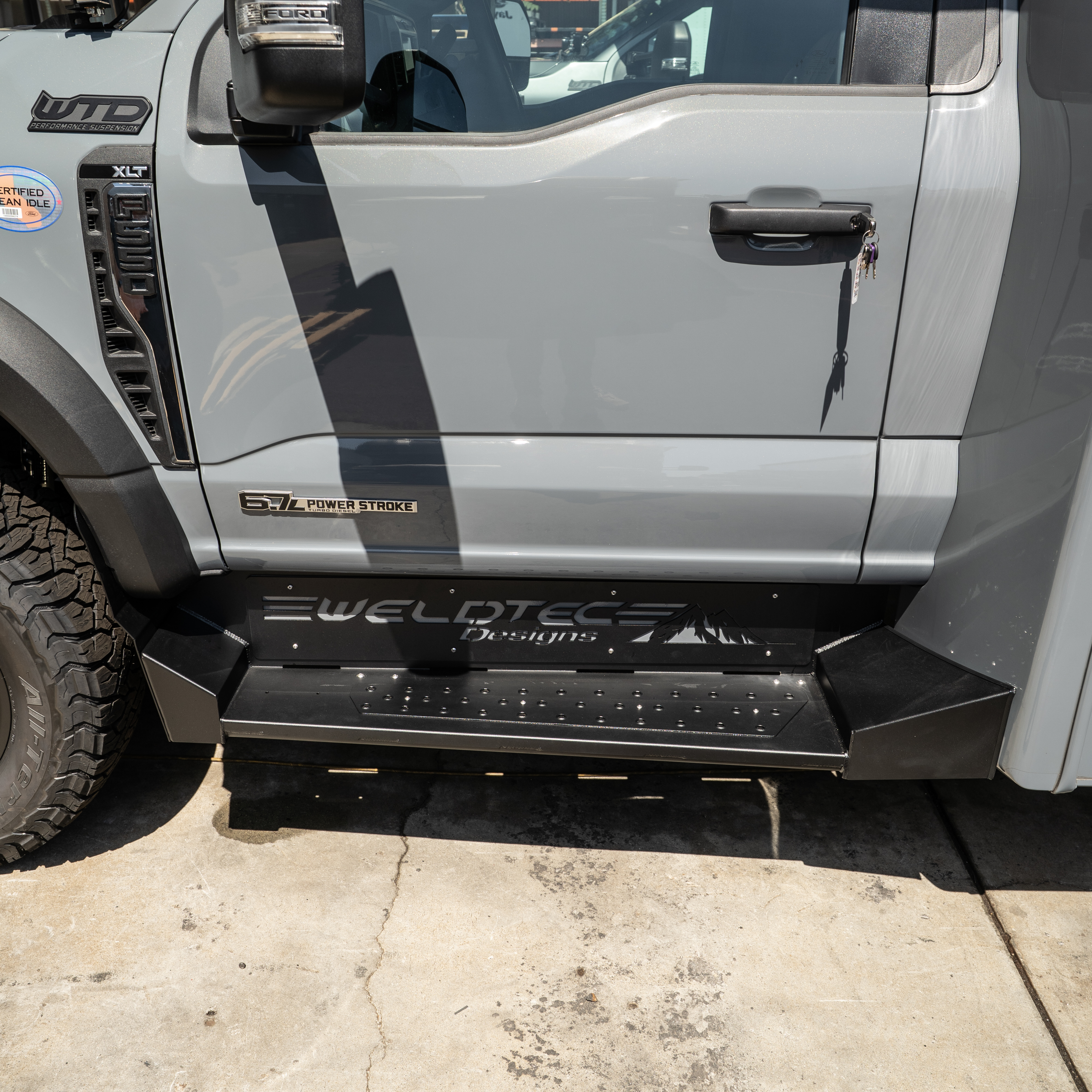 WeldTec Designs side steps for Ford F-550 and F-600 Super C RVs with wide step surface and integrated body-line fitment