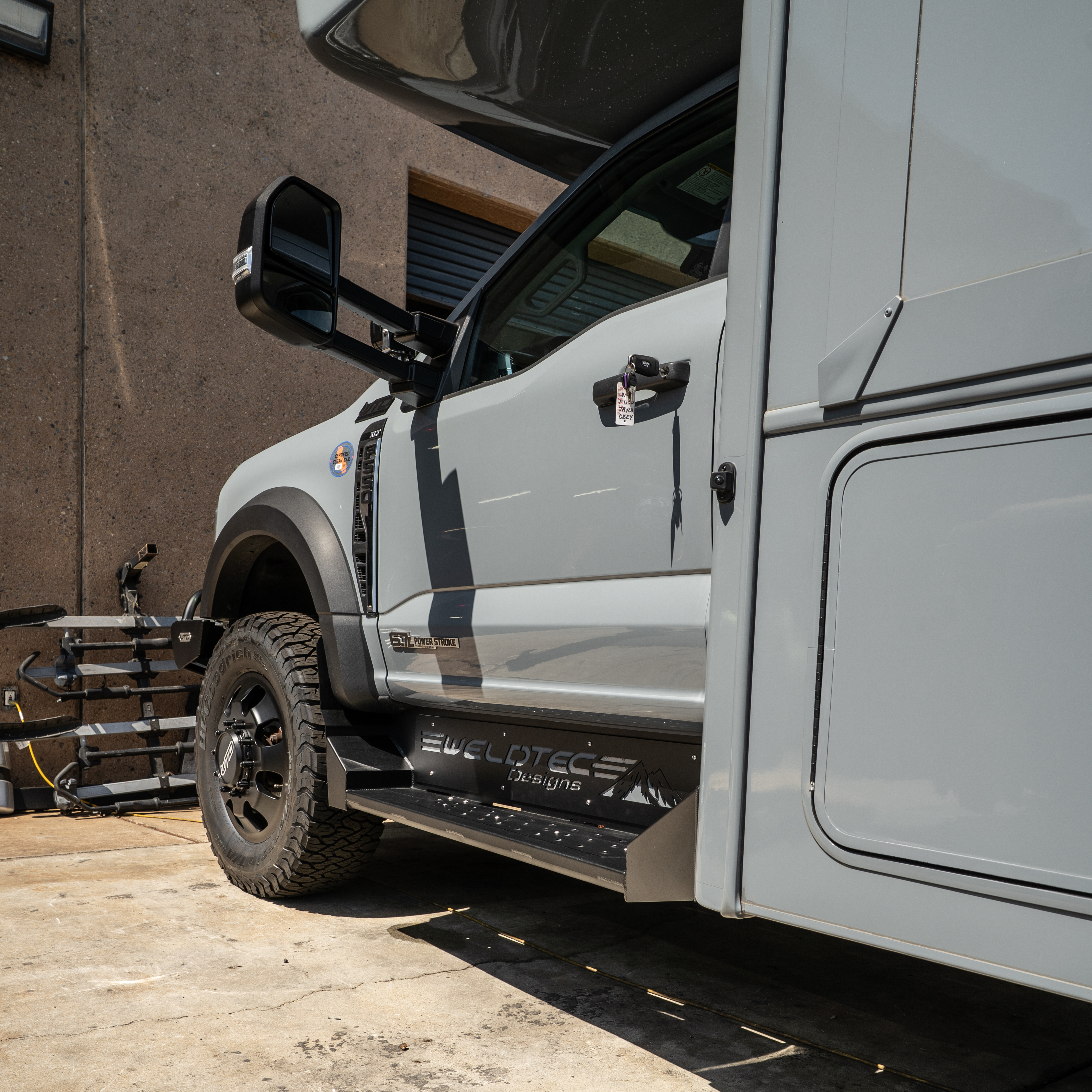 WeldTec Designs side steps for Ford F-550 and F-600 Super C RVs with wide step surface and integrated body-line fitment